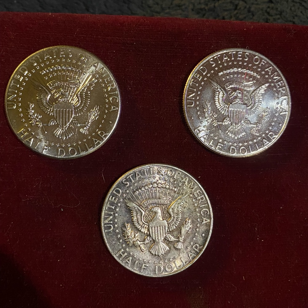 Three Kennedy half dollars that came out of a $10 roll